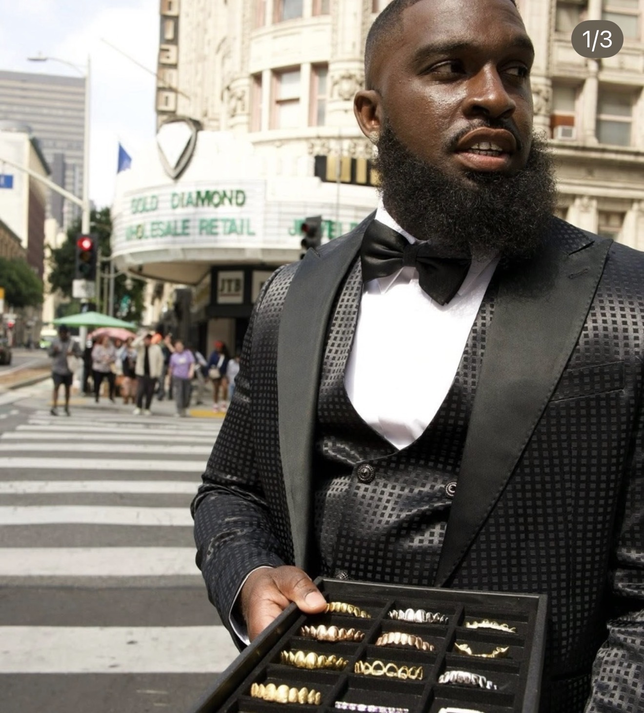 The jeweler presenting a tray of custom grillz downtown